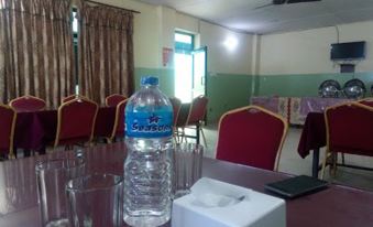 a conference room with a bottle of water and other items on a table , near chairs at Suva Hotel