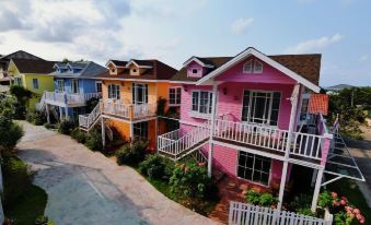 a group of colorful houses with balconies and railings are situated next to each other at Bunny Hill Resort
