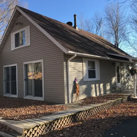 Cozy vacation home nestled in a quiet wooded area. Near town but private