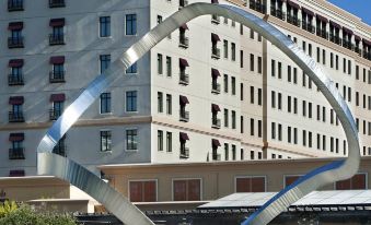 a modern building with a large metal sculpture in front , likely a hotel or office building at Juniper Hotel Cupertino, Curio Collection by Hilton