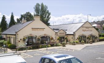 "a car is parked in front of a building with the sign "" hotel "" on it" at Premier Inn Glasgow (Milngavie)