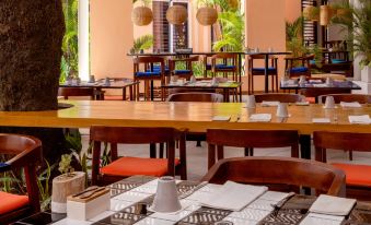 a large dining area with tables and chairs arranged for a group of people to enjoy a meal together at Salt of Palmar, Mauritius
