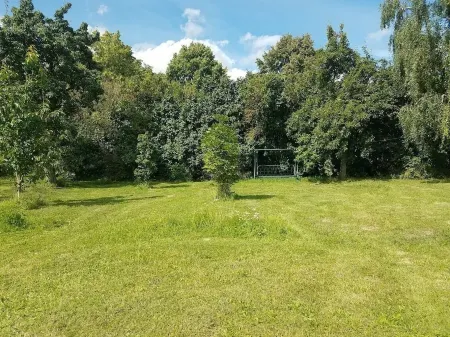 Holiday house with a large garden and swimming lake in the village