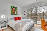 Luxurious midcentury modern glass house in the woods, chefs kitchen & great art