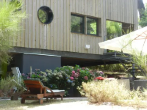 Wooden house in the golf, between forest, lake and ocean