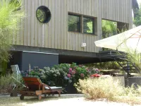 Wooden house in the golf, between forest, lake and ocean