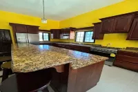 Nature view in a quiet urban neighborhood 1-bedroom house with WiFi and AC Hotels in Corozal