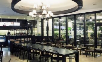 a large dining room with a long table and numerous chairs arranged for a group of people at Incheon Airport Hotel