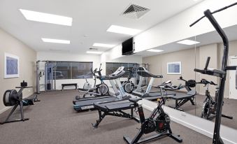 a well - equipped gym with various exercise equipment , such as treadmills , stationary bikes , and weight machines at Quest Mawson Lakes