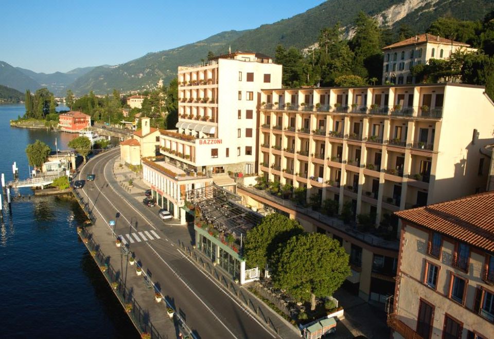 a city street with buildings on both sides and a car driving down the road at Hotel Bazzoni