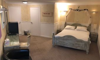 a modern bedroom with white walls , wooden furniture , and beige carpet , featuring a bed with two nightstands and a black armchair at The Willow House