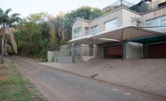 a modern house with a large carport attached to the side of the building , situated in a residential area at Scenic Views