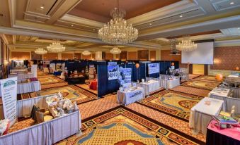 a large room with multiple tables and chairs set up for an event , possibly a wedding or conference at Little America Hotel & Resort Cheyenne