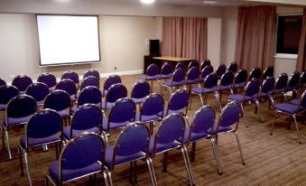 a conference room with rows of chairs arranged in a semicircle , ready for a meeting or presentation at Skylark Hotel