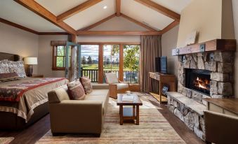 a cozy living room with a couch , a chair , and a fireplace , as well as a fireplace and a tv at Sunriver Resort