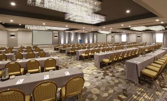 a large conference room with rows of chairs and tables , all facing the same direction at San Mateo Marriott San Francisco Airport