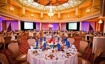 a large , well - decorated ballroom filled with tables and chairs , set up for a formal event at Safety Harbor Resort & Spa, Trademark Collection by Wyndham
