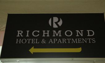 "a black and white sign with the words "" richmond hotel & apartments "" written on it" at Richmond Hotel Sylhet