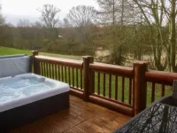 Lakeside Log Cabin with hot tub overlooking the water.
