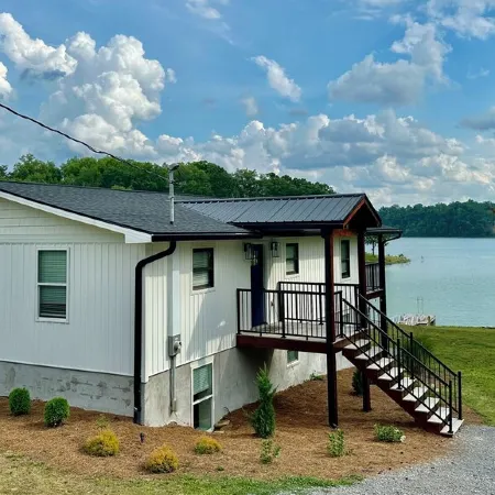 BRAND NEW Lake Front home. Private cove and boat dock! Modern farmhouse appeal!