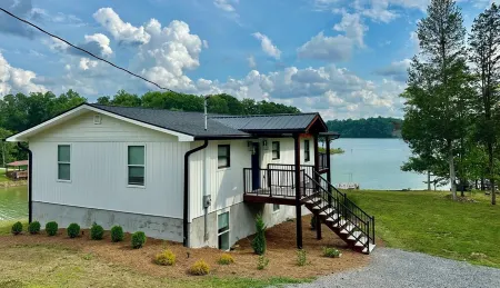 BRAND NEW Lake Front home. Private cove and boat dock! Modern farmhouse appeal!