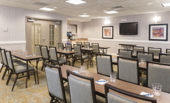 a dining area with tables and chairs arranged for a group of people to sit and enjoy their meal at Homewood Suites by Hilton Bloomington