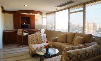 a cozy living room with two couches and a coffee table , creating a comfortable space for relaxation at El Paseo Hotel