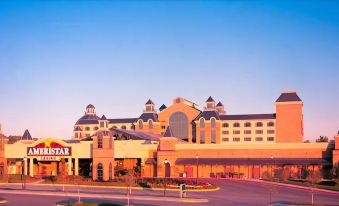 a large hotel with a large parking lot in front of it , under a clear blue sky at Ameristar Casino Hotel Council Bluffs