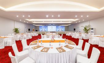 a large , well - lit conference room with multiple round tables set for a meeting or event at Sun Siyam Olhuveli