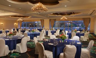 a well - decorated banquet hall with multiple round tables covered in white tablecloths and set for a formal event at St. Kitts Marriott Resort & the Royal Beach Casino