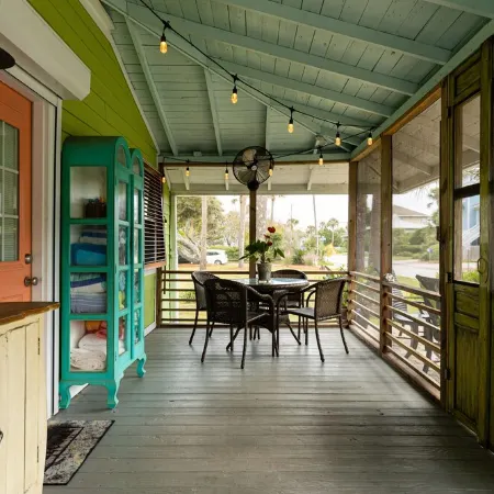Family getaway with screened-in porch steps from surf and sun!