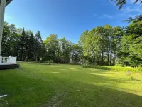 Spacious five-bedroom home off Back Lake with direct trail access on Spooner Rd