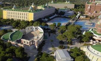 a large , ornate hotel complex with multiple buildings and a water feature in the foreground at Kremlin Palace