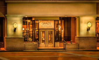 "the entrance to a restaurant named "" graze "" with brick pillars and a large sign above it" at Winston-Salem Marriott