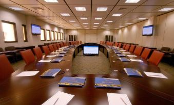 a large conference room with multiple chairs arranged in a long table , creating an elegant setting for a meeting at The Avalon, Durg