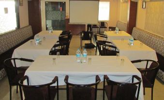 a conference room with tables , chairs , and water bottles set up for a meeting or presentation at Landmark Hotel