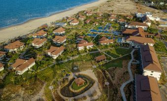aerial view of a resort with a large pool surrounded by buildings and a beach in the background at Tui Blue Nam Hoi An