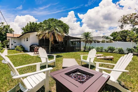Chic Coastal Bungalow with Fire Pit, Lanai, Games & Fully Fenced Yard