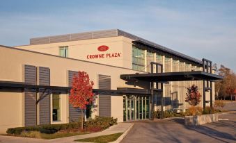 "a modern building with the sign "" crowne plaza "" on it , surrounded by trees and a clear sky" at Crowne Plaza Lombard Downers Grove