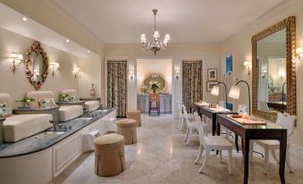 a dining room with a long table , chairs , and a chandelier hanging from the ceiling at Rosewood Bermuda