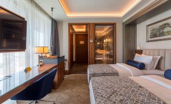 a hotel room with two beds , one on the left side of the room and the other on the right side at Golden Tulip Istanbul Bayrampasa