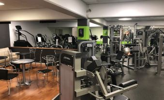 a well - equipped gym with various exercise equipment , such as treadmills , weight machines , and benches at Best Western Plus Airport Hotel Copenhagen