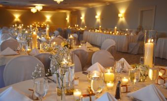 a beautifully decorated banquet hall filled with tables and chairs , all set for a wedding reception at Southampton Inn
