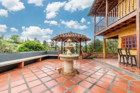 Chiriqui farm in Guatape in front of the Peñol stone