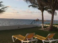Quiet and serene ocean front 2-bedroom 2-bathroom condo, steps from the sand!