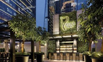 A restaurant with outdoor seating located next to a decorated building at The Langham, Shenzhen
