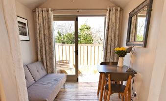 a cozy living room with a couch , a dining table , and a door leading to a patio at Grove Park