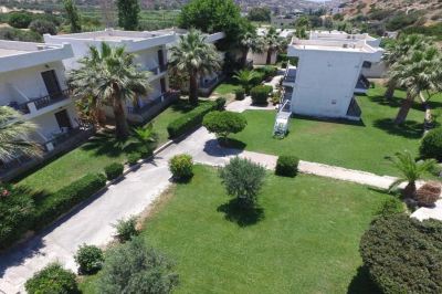 a bird 's eye view of a building surrounded by trees and bushes in a garden at Valley Village