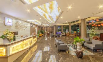 a modern and elegant lobby with marble flooring , large windows , and a reception desk , surrounded by comfortable seating and plants at Lake View Hotel