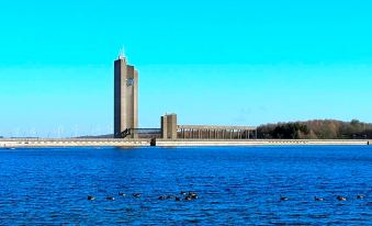 a large building is situated on an island in the middle of a body of water at La Cote d'Or